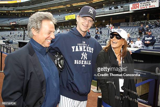 Of Donna Karan International, Mark Weber, Donna Karan, and Yankee Pitcher A.J. Burnett pose for a photo before the game at Yankee Stadium on April...