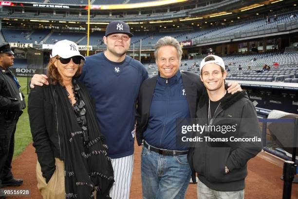 Donna Karan, Joba Chamberlain, CEO of Donna Karan, Mark Weber, and son pose for a photo before New York Yankees play against the Texas Rangers at...