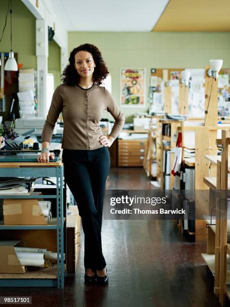 businesswoman standing in office - newbusiness stock pictures, royalty-free photos & images