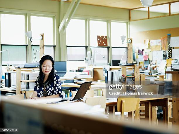 businesswoman working on laptop in office - newbusiness stock pictures, royalty-free photos & images