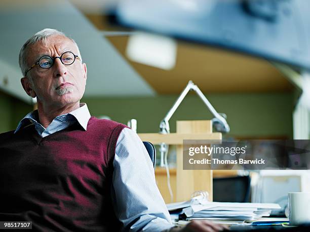 mature businessman looking at computer monitor  - newbusiness stock pictures, royalty-free photos & images