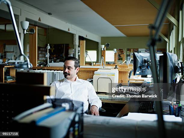 businessman sitting at workstation in empty office - newbusiness bildbanksfoton och bilder