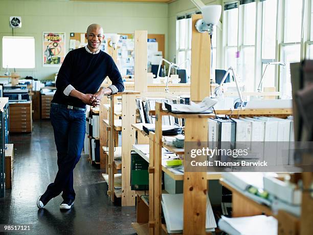 young architect leaning on workstation in office - newbusiness stock pictures, royalty-free photos & images