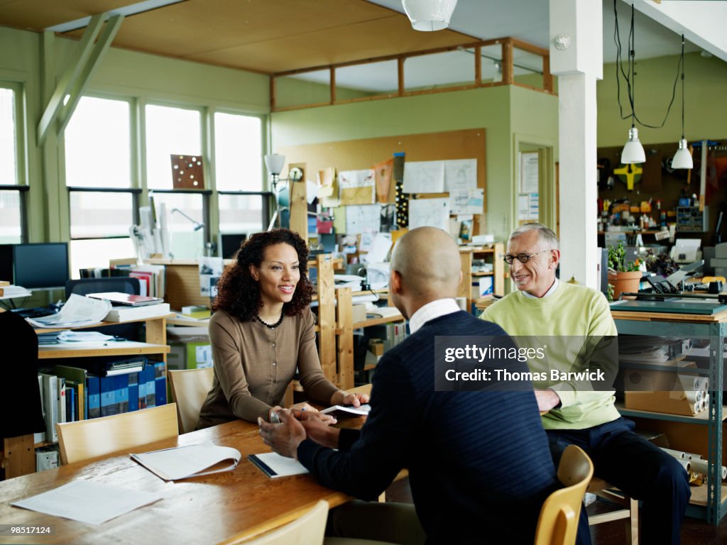 Coworkers in discussion at conference table