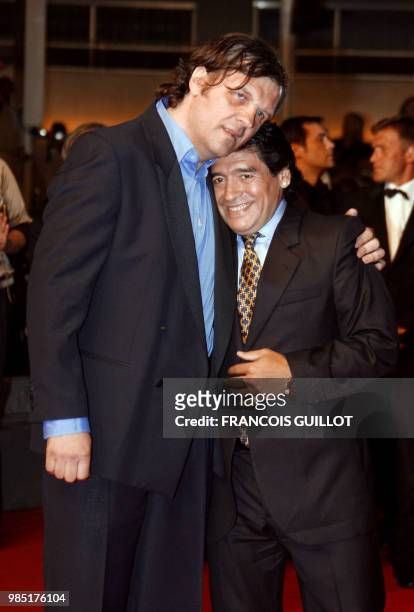 Former Argentinian football player Diego Maradona and Serbian director Emir Kusturica poses as they arrive to attend the screening of their...