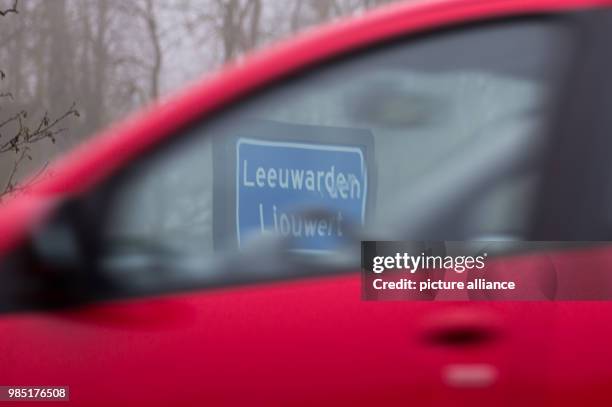 The town sign in the Dutch city Leeuwarden can be seen through the panes of a driving car in the Netherlands, 26 January 2018. The city Leeuwarden in...