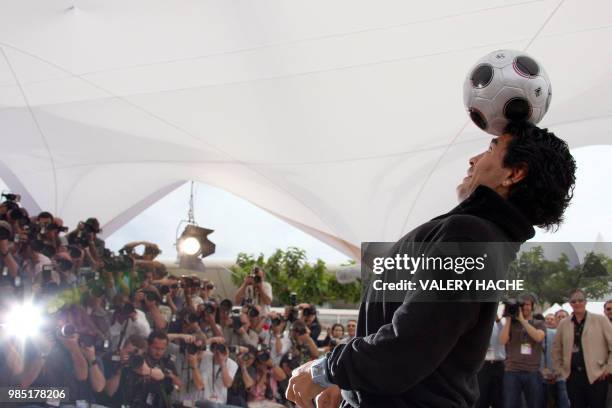 Former Argentinian football player Diego Maradona controls the ball during a photocall for Serbian director Emir Kusturica's film 'Maradona by...