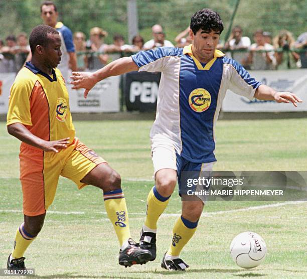 Former Argentine soccer player Diego Maradona fights for the ball with an unidentified player 31 January in Campinas, Brazil, 100km from Sao Paulo...