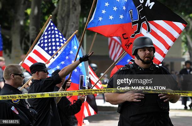 Members of the Neo-Nazi group, The American National Socialist Movement watch an angry crowd of counterprotesters as the group held a rally in front...