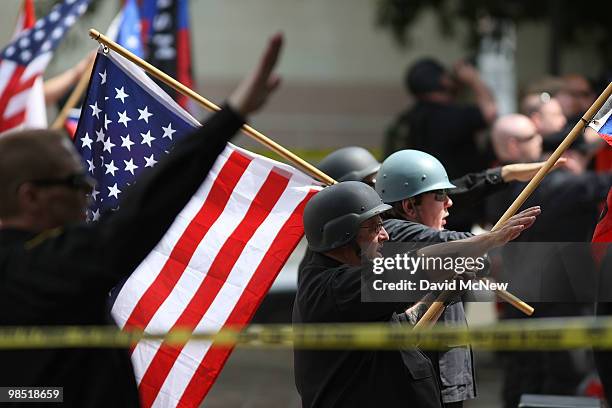 Members of the National Socialist Movement salute during a rally on near City Hall on April 17, 2010 in Los Angeles, California. An NSM anti-illegal...