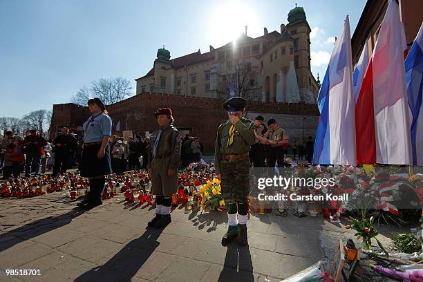 Members of the Polish Scouts youth organization stand guard in honor of the late polish President Lech Kaczynski and his wife Maria near the castle...