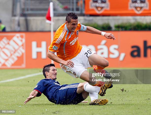 Geoff Cameron of the Houston Dynamo is tripped up by Sacha Kljestan of Chivas USA at Robertson Stadium on April 17, 2010 in Houston, Texas.