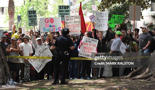 Police block an angry crowd of counterprotesters after the neo-nazi group, The American National Socialist Movement held a rally in front of the Los...