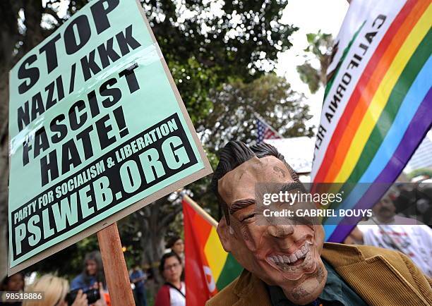 Man with a mask of California Governor Arnold Schwarzenegger attends a demonstration of counterprotesters after the neo-nazi group, The American...
