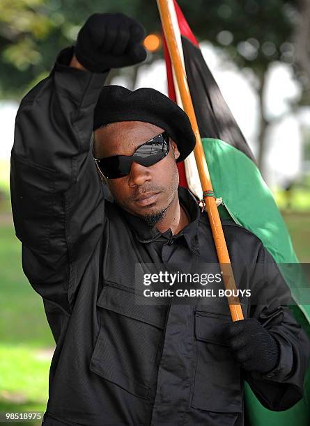 Member of the New Black Panthers group, raises his arm during a demonstration of counterprotesters after the neo-nazi group, The American National...