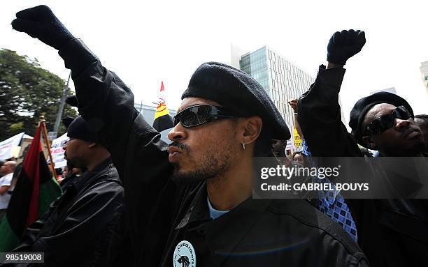 Members of the New Black Panthers group, raise their arms during a demonstration of counterprotesters after the neo-nazi group, The American National...