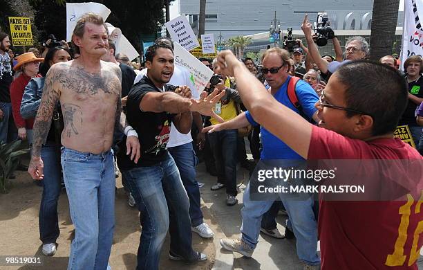 Plainclothes police remove a man with nazi skin tattoo's after he was beaten by an angry crowd of counterprotesters before the neo-nazi group, The...