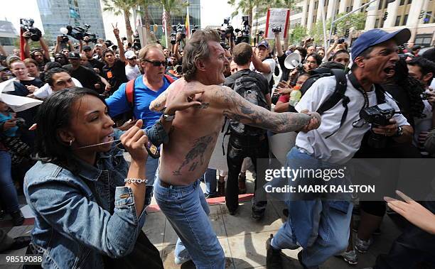 Plainclothes police remove a man with nazi skin tattoo's after he was beaten by an angry crowd of counterprotesters before the neo-nazi group, The...