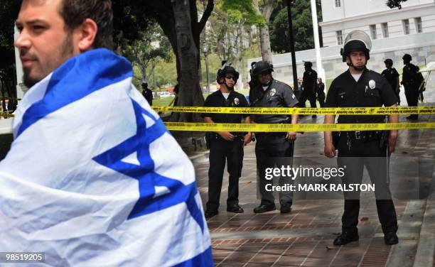 Jewish anti-racism protester stands in front of a LAPD police line to protect members of the neo-nazi group, The American National Socialist Movement...