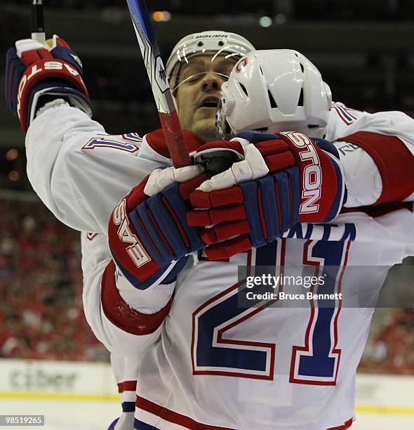 Andrei Markov of the Montreal Canadiens hugs Brian Gionta following Gionta's first period goal against the Washington Capitals in Game Two of the...