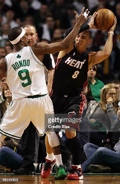 Carlos Arroyo of the Miami Heat tries to pass as Rajon Rondo of the Boston Celtics defends during Game One of the Eastern Conference Quarterfinals of...