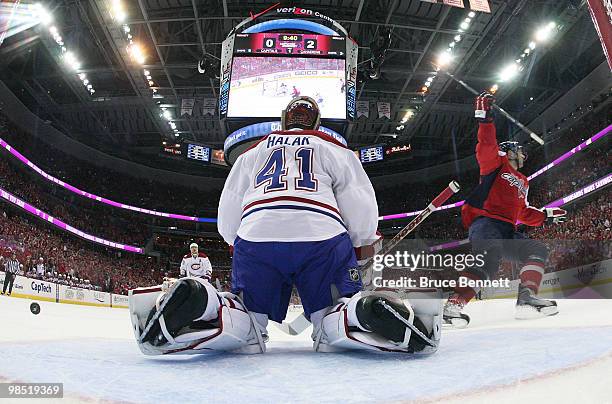 Jaroslav Halak of the Montreal Canadiens can't stop a first period shot by Eric Fehr of the Washington Capitals in Game Two of the Eastern Conference...