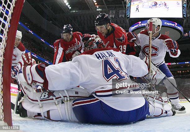 Jaroslav Halak of the Montreal Canadiens defends the net against Eric Fehr and David Steckel of the Washington Capitals in Game Two of the Eastern...