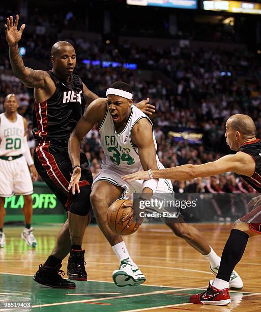 Paul Pierce of the Boston Celtics tries to drive around Quentin Richardson and Carlos Arroyo of the Miami Heat during Game One of the Eastern...