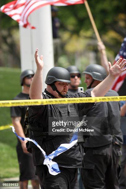 Member of the National Socialist Movement rips up a flag of Israel during an NSM rally near City Hall on April 17, 2010 in Los Angeles, California....