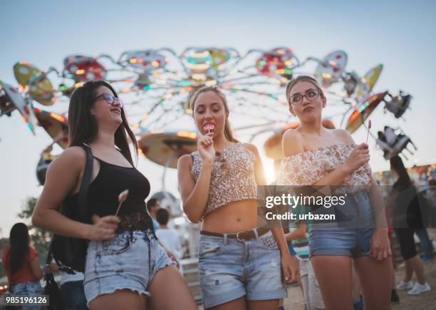 girls fooling around with lollipops - girl lollipops stock pictures, royalty-free photos & images