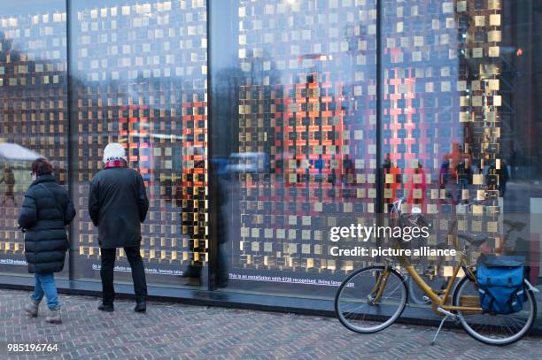 Passerbys standing in front of an installation, which visualizes 6720 living languages in Leeuwarden, Netherlands, 26 January 2018. Leeuwarden in the...