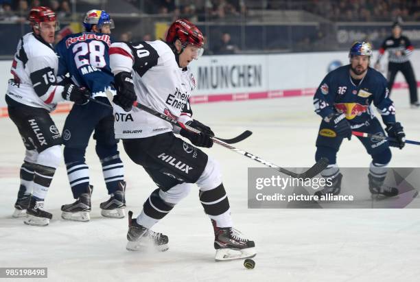 Munich's Frank Mauer and Cologne's Christian Ehrhoff vie for the puck during the DEL match between EHC Red Bull Muenchen and Cologne Sharks at the...