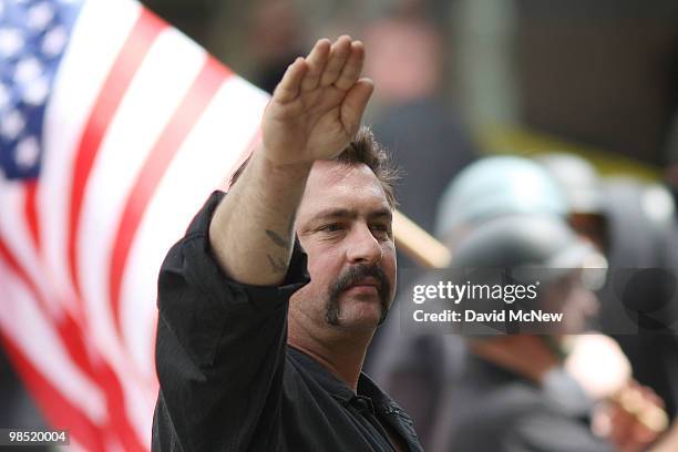 Member of the National Socialist Movement salutes during a rally near City Hall on April 17, 2010 in Los Angeles, California. An NSM anti-illegal...