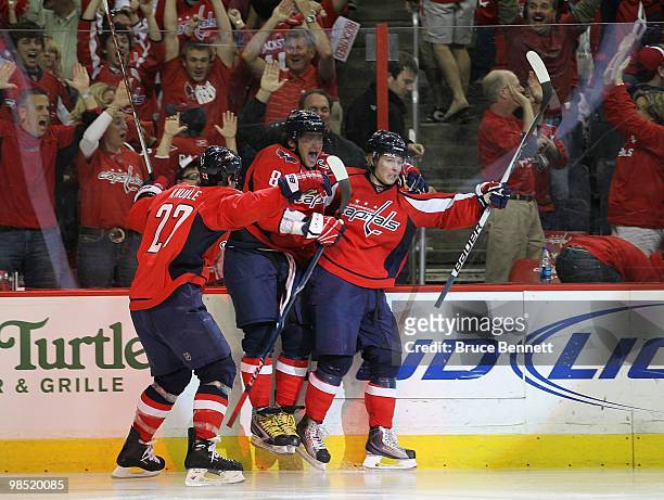 Nicklas Backstrom of the Washington Capitals scores in overtime and is joined by Mike Knuble and Alex Ovechkin to defeat the Montreal Canadiens 6-5...