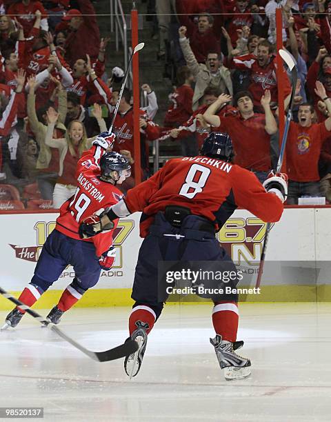 Nicklas Backstrom of the Washington Capitals scores his third goal of the game in overtime and is joined Alex Ovechkin as they defeat the Montreal...