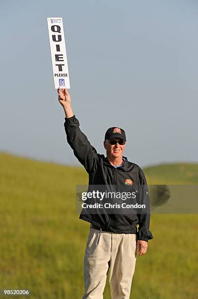 Volunteer holds a quiet sighn on the 18th tee during the third round of the Fresh Express Classic at TPC Stonebrae on April 17, 2010 in Hayward,...