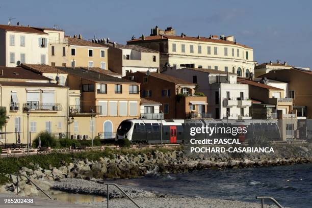 Train travels in front of L'Ile-Rousse on June 26, 2018 on the French Mediterranean island of Corsica. - Since January 2012, the Corsica railway...