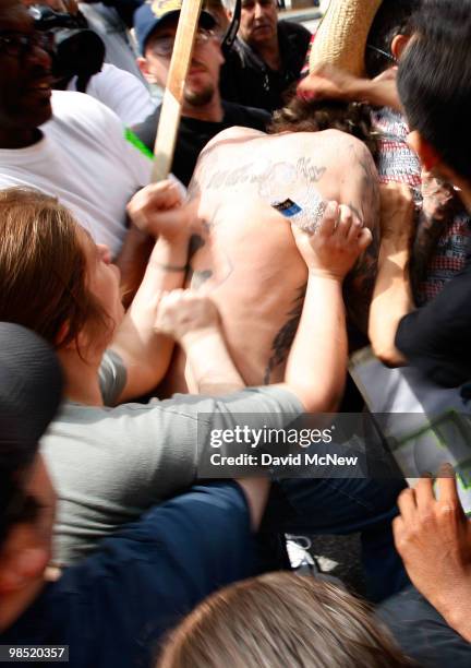 Reportedly homeless man is attacked by anti-neo-Nazi demonstrators before the start of a rally by the National Socialist Movement neo-Nazi group near...