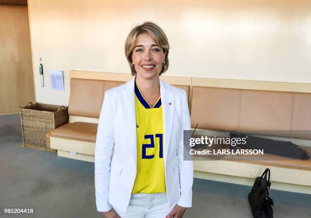 Sweden's Minister for Social Affairs Annika Strandhäll poses as she is dressed in a football jersey with the number of Sweden's national football...