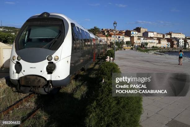 Train travels in front of L'Ile-Rousse on June 26, 2018 on the French Mediterranean island of Corsica. - Since January 2012, the Corsica railway...