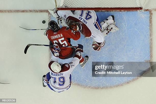 Jaroslov Halak of the Montreal Canadiens makes a save on Jason Chimera of the Washington Capitals during Game Two of the Eastern Conference...