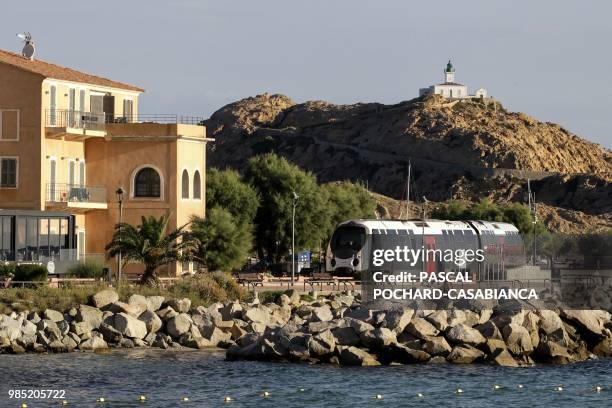Train travels in front of L'Ile-Rousse on June 26, 2018 on the French Mediterranean island of Corsica. - Since January 2012, the Corsica railway...