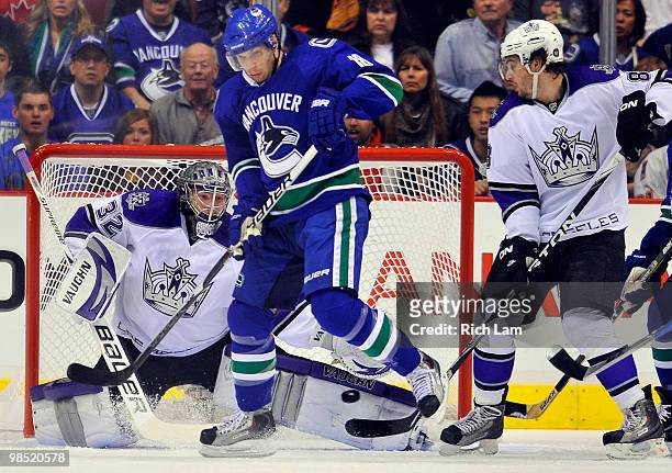 Goalie Jonathan Quick of the Los Angeles Kings makes a pad save while Steve Bernier of the Vancouver Canucks tries to screen during the first period...