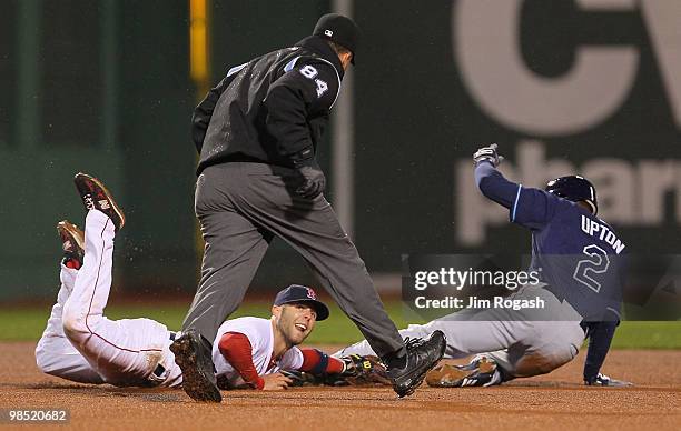 Kevin Youkilis of the Boston Red Sox attempts to pick off Carl Crawford of the Tampa Bay Rays at Fenway Park on April 17, 2010 in Boston,...