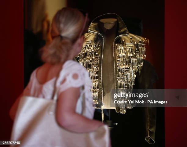 Visitor looking at Michael Lee Bush's Michael Jackson's 'dinner jacket', during a press preview of Michael Jackson: On the Wall exhibition at the...