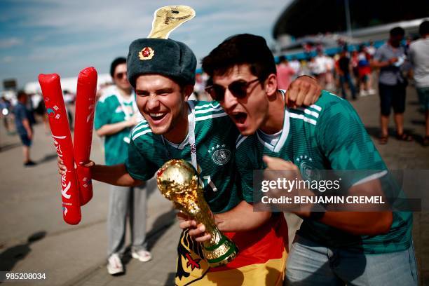 Germany supporters pose for a picture ahead of the Russia 2018 World Cup Group F football match between South Korea and Germany at the Kazan Arena in...