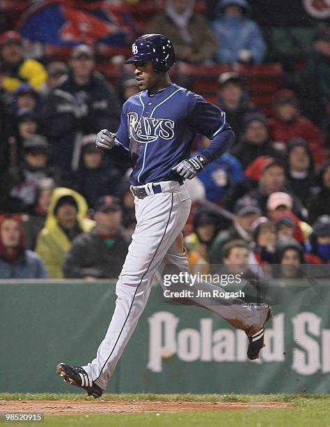 John Jaso of the Tampa Bay Rays knocks in teammate B.J. Upton against the Boston Red Sox throws against the Tampa Bay Rays at Fenway Park on April...