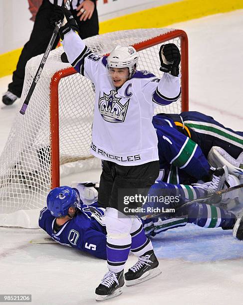 Dustin Brown of the Los Angeles Kings celebrates teammate's Fredrik Modin's , goal while Christian Ehrhoff and goalie Roberto Luongo lay on the ice...