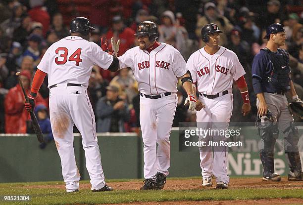 Kevin Youkilis of the Boston Red Sox hits a home run against the Tampa Bay Rays at Fenway Park on April 17, 2010 in Boston, Massachusetts.