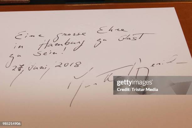 Swiss-Argentinian pianist Martha Argerich signs the golden book at Hamburg City Hall on June 27, 2018 in Hamburg, Germany.